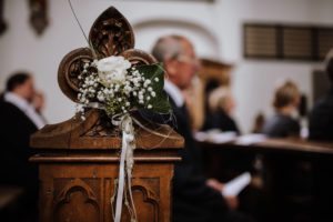 Weiße Rose und Schleierkraut auf einer Kirchenbank während der standesamtlichen Trauung Düsseldorf.
